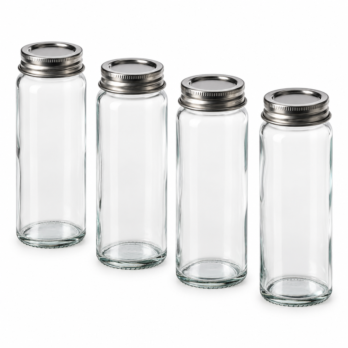 Set de cuatro especieros IKEA CITRONHAJ de vidrio transparente con tapas metálicas.